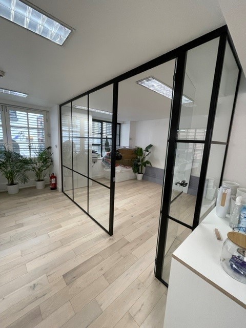 Modern glass wall partition with black piping