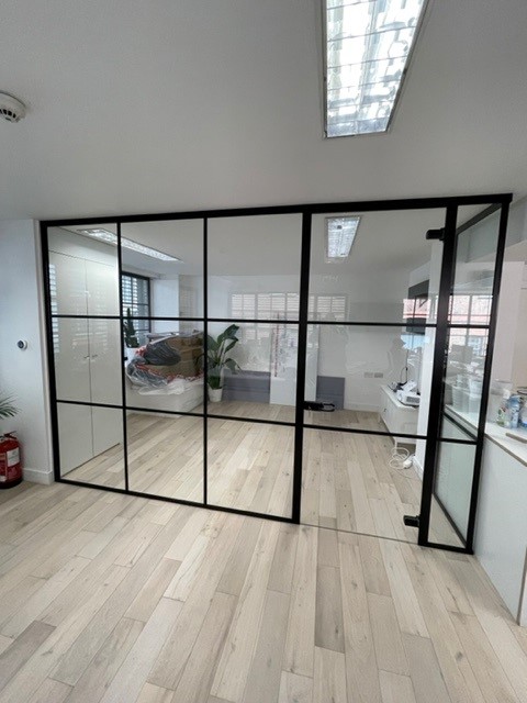 Large modern glass wall partition with black boxed borders