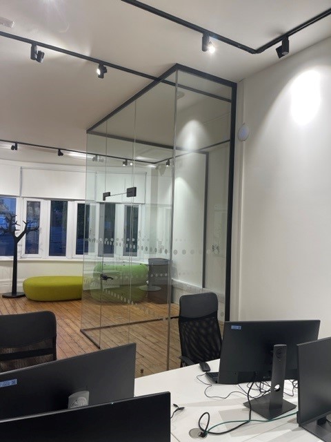Office space with glass partition for separate meetings