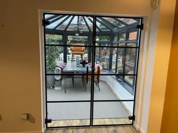 Closedmglass door partitions for the home using stylish black crittall banding strips to separate conservatory