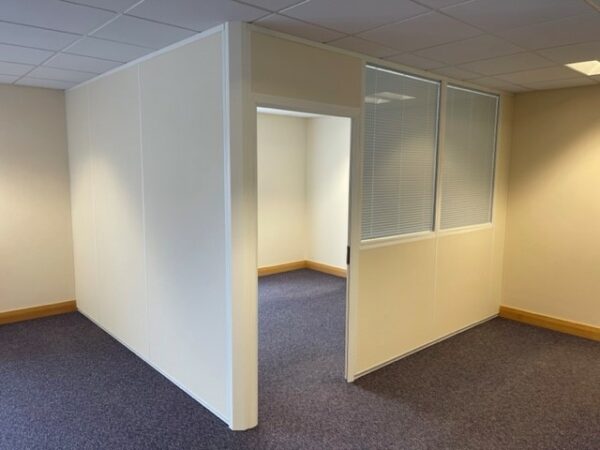 Separated office with solid partition walls and open door