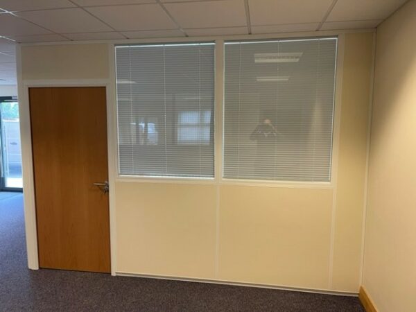 Office partitioning system creating separated office space with double glazed partition